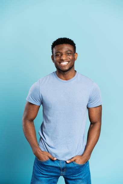 istock Attractive handsome african man standing isolated on blue background looking at camera 1748512394