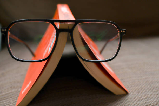 istock reading glasses and a book in the background 1748514612
