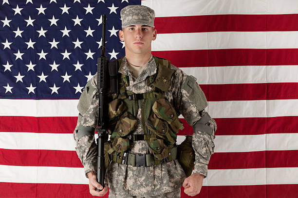 istock Army man standing in front of American flag 174851856