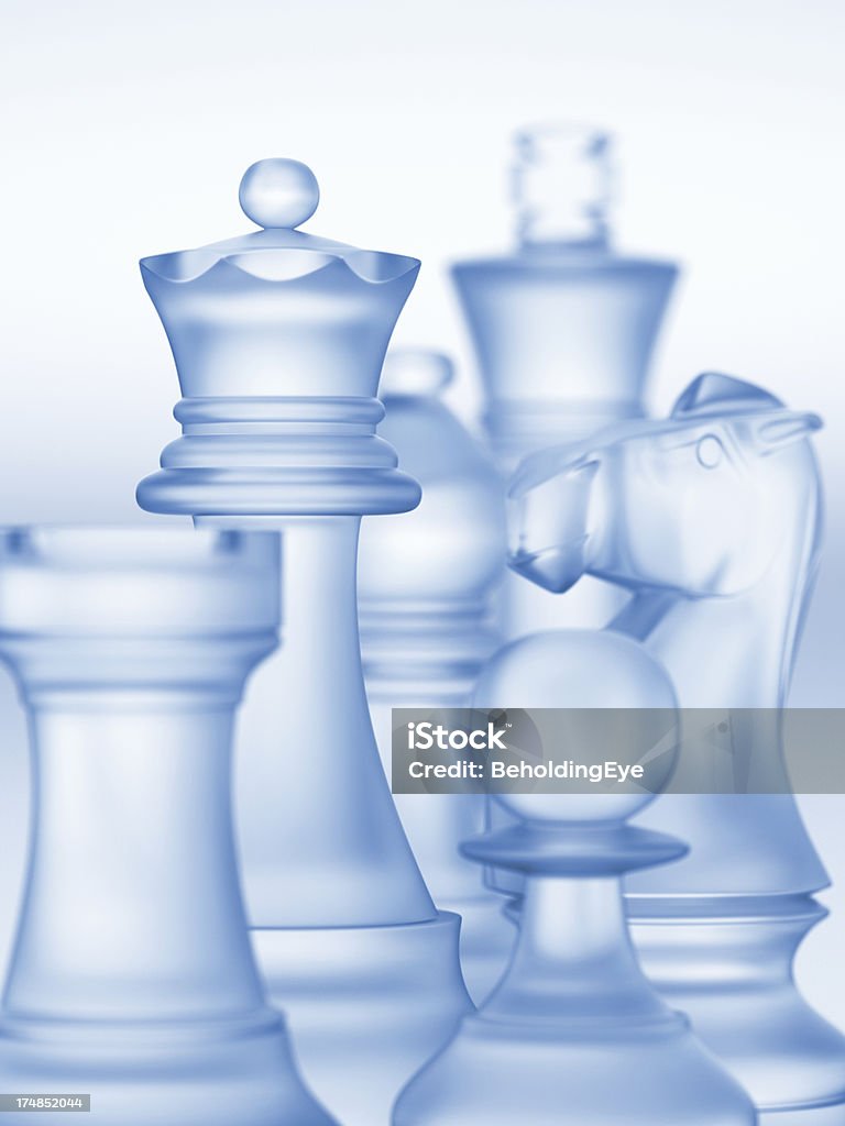 Close-up of a digital image of chess pieces made of glass Glass chess pieces. Very selective focus on part of the queen. Back Lit Stock Photo