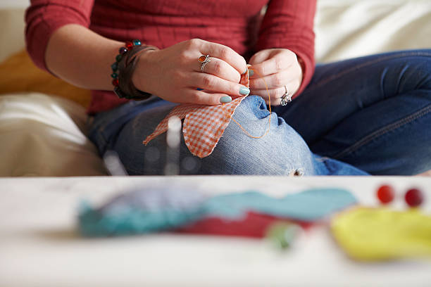 cucire processo. - craft product women sewing human knee foto e immagini stock