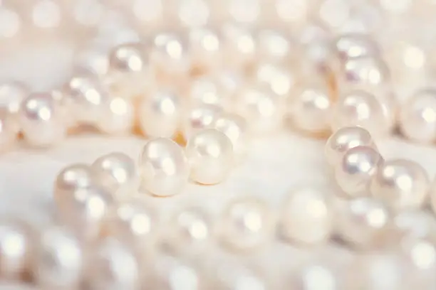 Pearls scattered on a white background