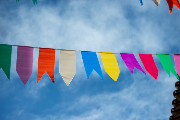 istock Festive decoration flags of different colors hanging with string. 1748525579
