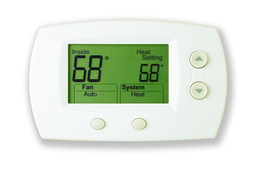 Close up of a Digital Thermostat isolated against a white background with a soft drop shadow. Thermostat is set on an energy-efficient setting of 68 Degrees.