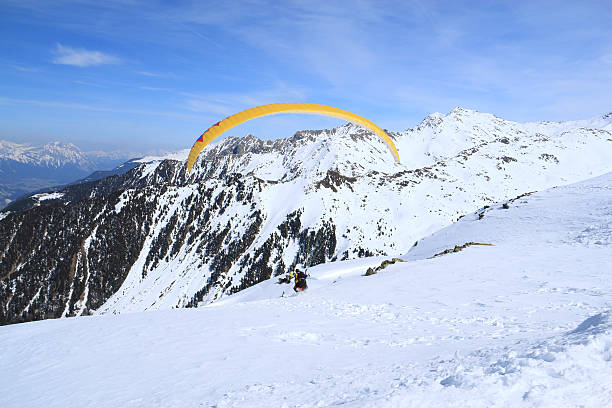 Tandem paraglider starts to fly.