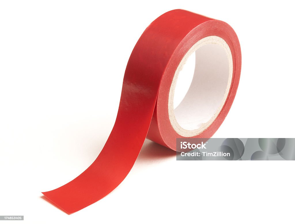 Red Tape Isolated on White Roll of red insulating tape isolated on a white background. Can be used as a metaphor for 'red tape' restrictions for a variety of business and public sector concepts. Rolled Up Stock Photo