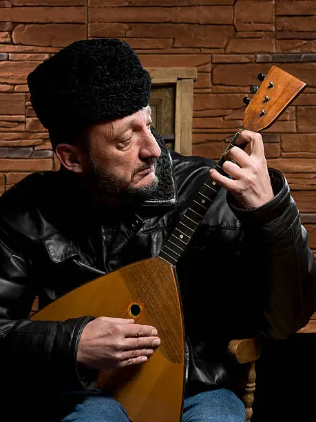 Russian musician touching a balalaika