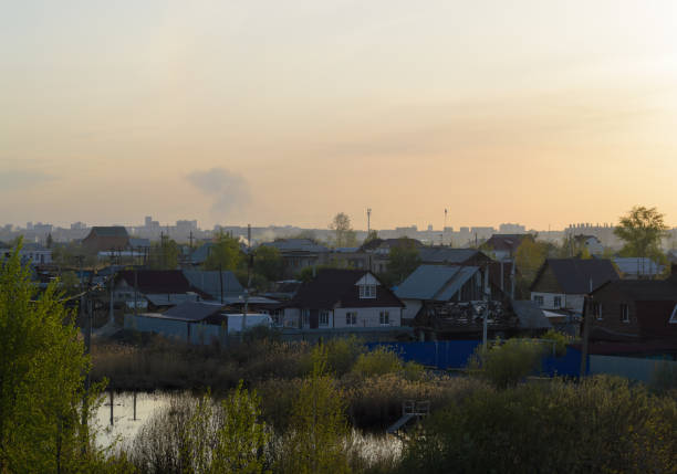 Evening landscape with village houses in the sunset sunlight