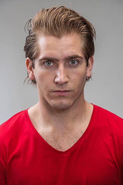 Young man (real people) Serious young man (real people) on gray background mediterranean ethnicity stock pictures, royalty-free photos & images