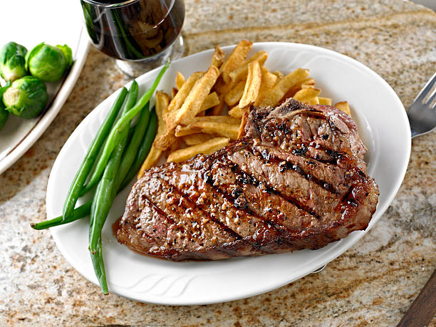 Grilled New York Steak with French Fries and Red Wine.
