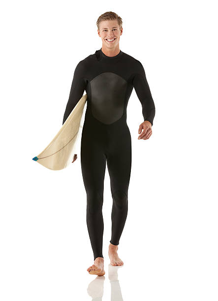 istock Smiling male surfer carrying a surfboard 174854043