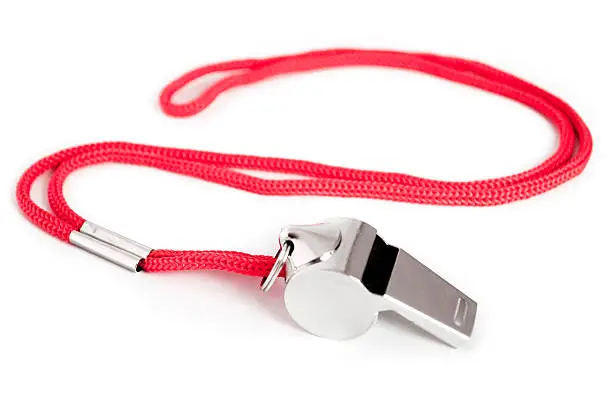 Metal whistle with red string.