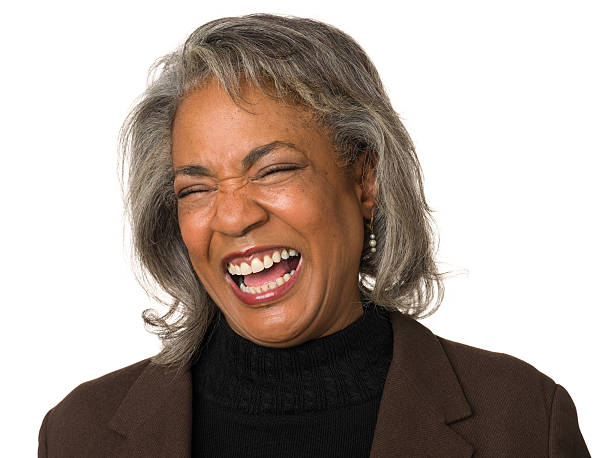 hysterical laughing mature woman - ogen dicht closeup vrouw 50 jaar stockfoto's en -beelden