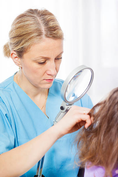 istock Woman inspect childs head for lice 174854709