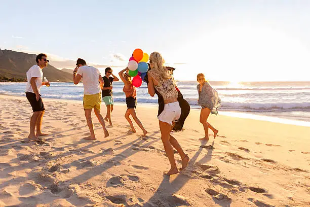 Photo of Young Party People having fun at the beach