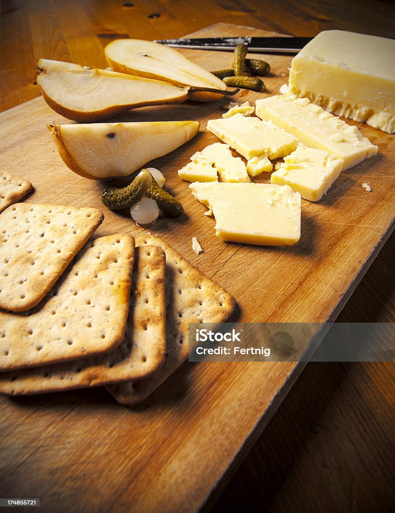 シャープ製チェダーチーズ、ペアーズ - まな板のロイヤリティフリーストックフォト