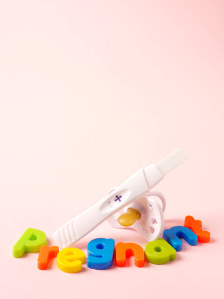 Pregnancy Test Results with a Pacifier on Pink