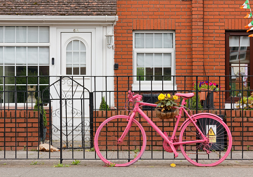 Dublin, Ireland - August 3, 2023: Beautiful typical house with a decorative pink bycicle outside the front door
