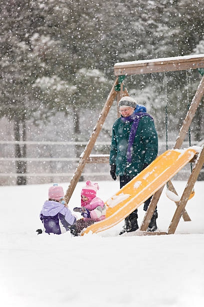 istock Grandma & Granddaughters Playing in Snow 174856249