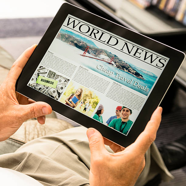 istock Man holding a tablet with newspaper 174856258