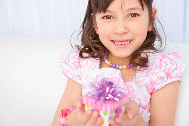 istock Birthday girl holding her present 174856406
