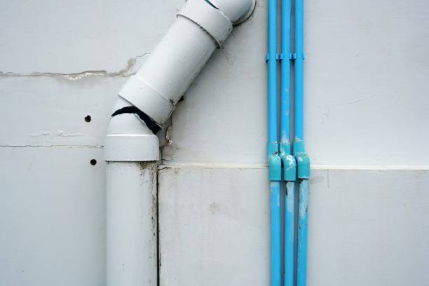 istock Close up a white broken plastic pipe with small blue plastic pipe on the wall of the building 1748564421