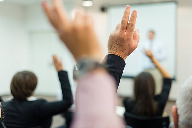 istock Business executives raising hands in seminar 174856872