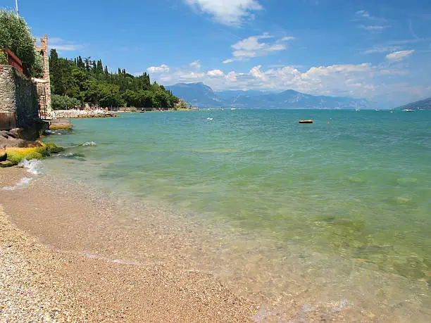 Beautiful beach on Sirmione peninsula, Garda Lake, Italy.