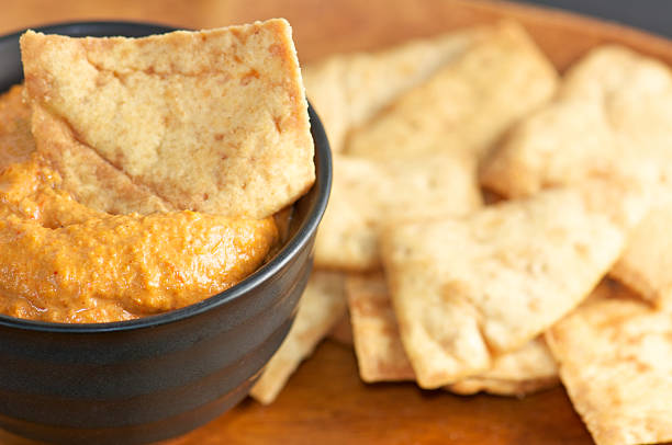 istock Red Pepper Dip in Black Bowl with Pita chips 174856933