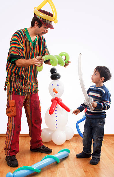 Entertainer at birthday party making balloon animals and objects for a little boy.Similar photos with this model: