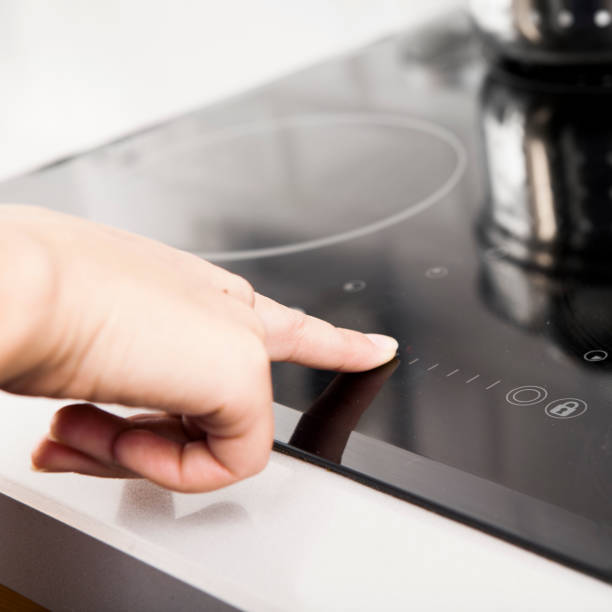istock woman touching electric hob 174857594