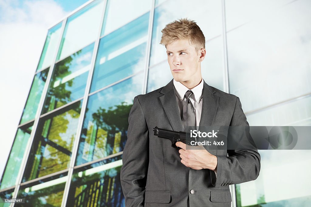 Security businessman aiming with a handgun Security businessman aiming with a handgunhttp://www.twodozendesign.info/i/1.png Adult Stock Photo