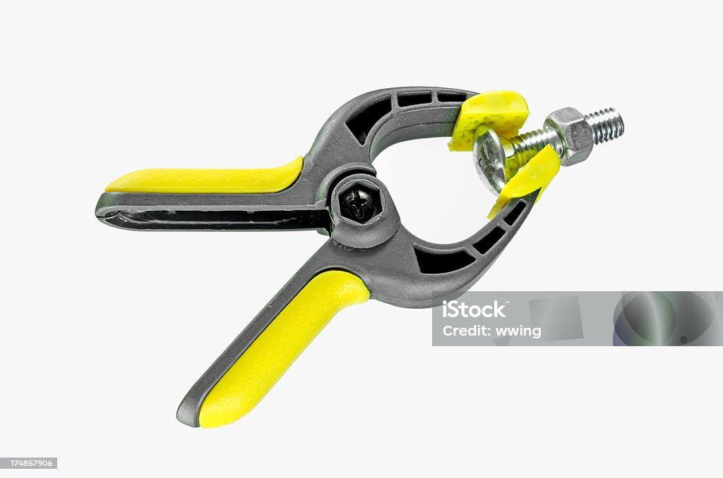 Shop Clamp And Bolt A wood and tool clamp  with a new nut and bolt in its jaws isolated....  on a white background with copy space. Bolt - Fastener Stock Photo