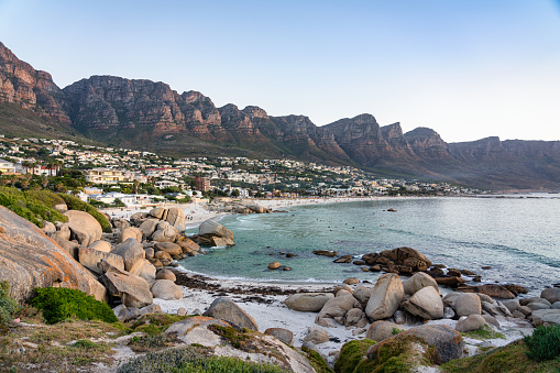 XXL aerial panoramic drone view of Camps Bay, an affluent suburb of Cape Town, South Africa. With its white beach, Camps Bay attracts many tourists. Twelve apostles mountain range in the background.