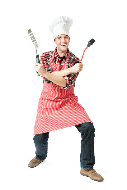 Subject: An happy animated outdoor grilling chef holding grilling tools on white background.