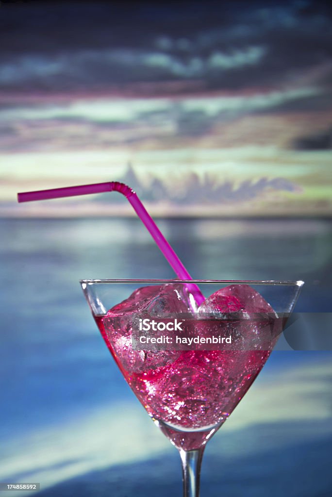 Cocktail with pink straw against beach and sunset background Pink Cocktail with pink straw against beach and sunset background Alcohol - Drink Stock Photo