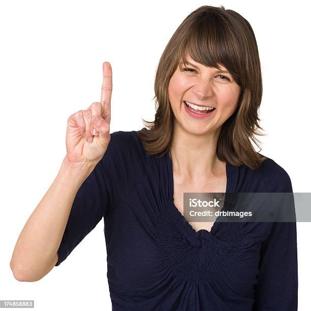 Foto de Feliz Mulher Gestos Um Dedo Número Um Sinal Manual e mais fotos de stock de Número 1 - Número 1, Gesto de dedo Número Um, Dedo - Termo anatômico