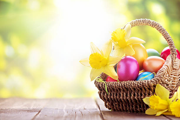 istock Colorful easter eggs and daffodils on green nature background 174858890