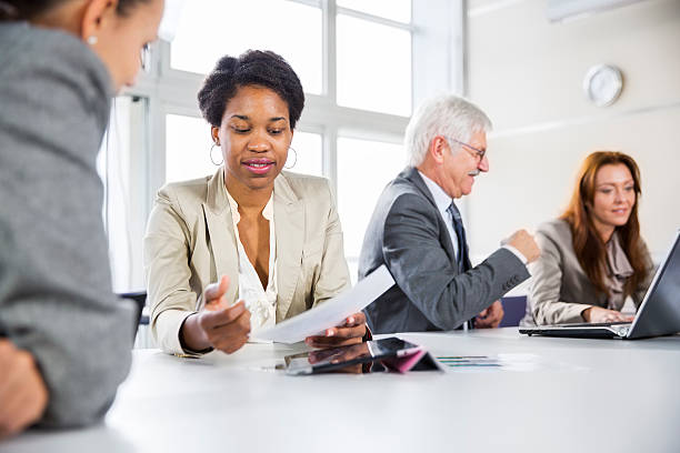 istock Business meeting... black woman checking data on digital tablet 174858915