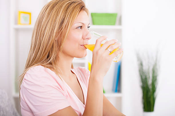 istock Woman drinking juice 174859039