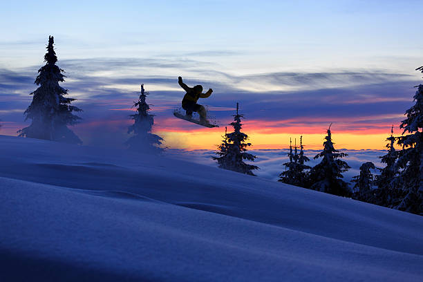 Extreme Snowboarding. Freestyle snowboarder jumping in the air.Beautiful nature in a sunset time. Powder snow.SEE ALSO: