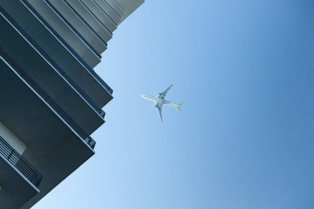 istock Passenger Airliner Flying Over the Urban City 174859645