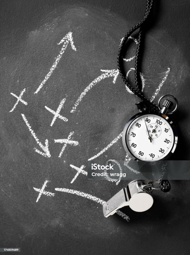Arrows with Crosses on the Blackboard, a Whistle and Stopwatch Stopwatch and whistle with chalk arrows and crosses drawn on a blackboard.Click on the link below to see more of my sport and business images Stopwatch Stock Photo