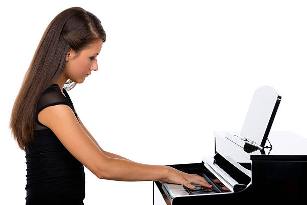 istock young woman playing piano 174859987