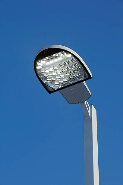 istock Illuminated LED Streetlight against a Clear Blue Sky 174860047