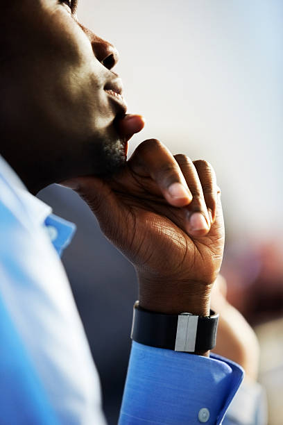 Young African businessman lost in thought with his hand on chin