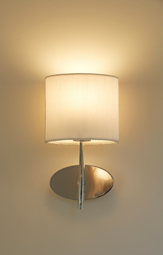a pretty champagne coloured wall lamp creating a nice warm glow on a cream coloured wall.Please see my other Interior and Architectural images by clicking on the Lightbox link below...A>AA>A