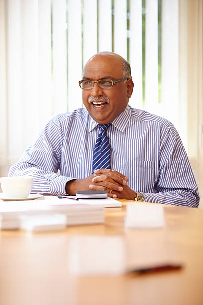 istock Indian businessman smiling in a meeting at office 174860227