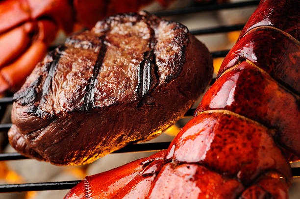 surf and turf - orange lobster steak surf and turf fotografías e imágenes de stock