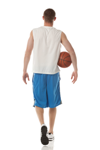 Rear view of basketball player walking